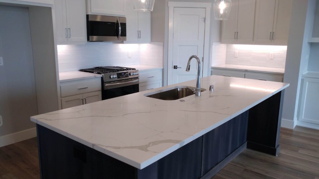 A kitchen with white quartz with gray veins