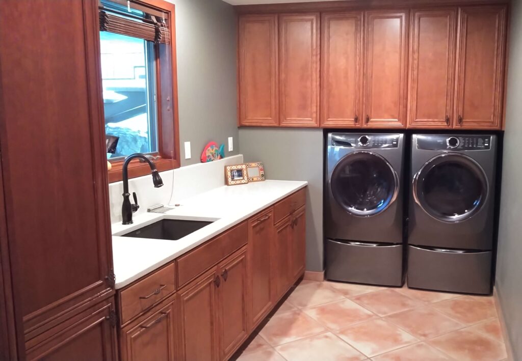 Laundry room with light countertops and tall backsplash